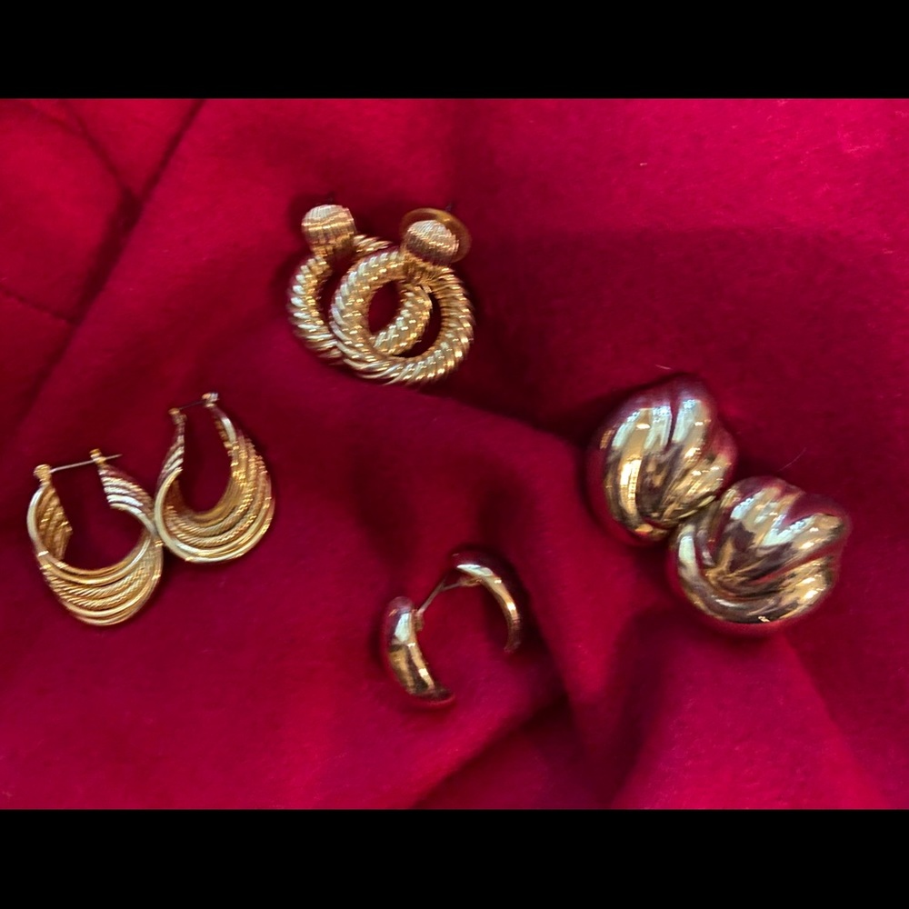 Bundle of gold pierced earrings.